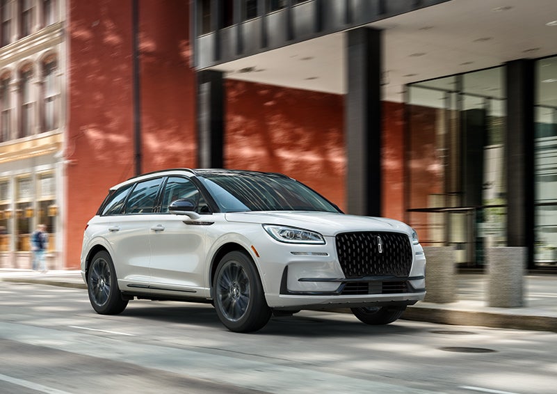 The 2024 Lincoln Corsair® SUV with the Jet Appearance Package and a Pristine White exterior is parked on a city street. | Boulevard Lincoln in Georgetown DE